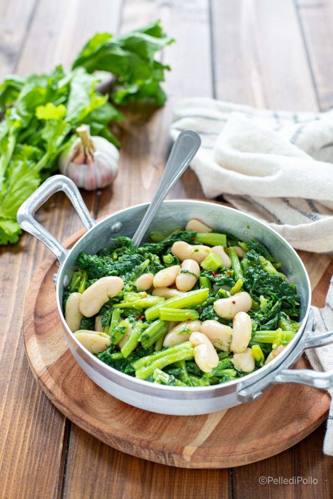 broccoli rabe in a skillet with beans