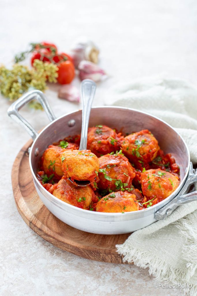 chickpea meatballs simmering in tomato sauce