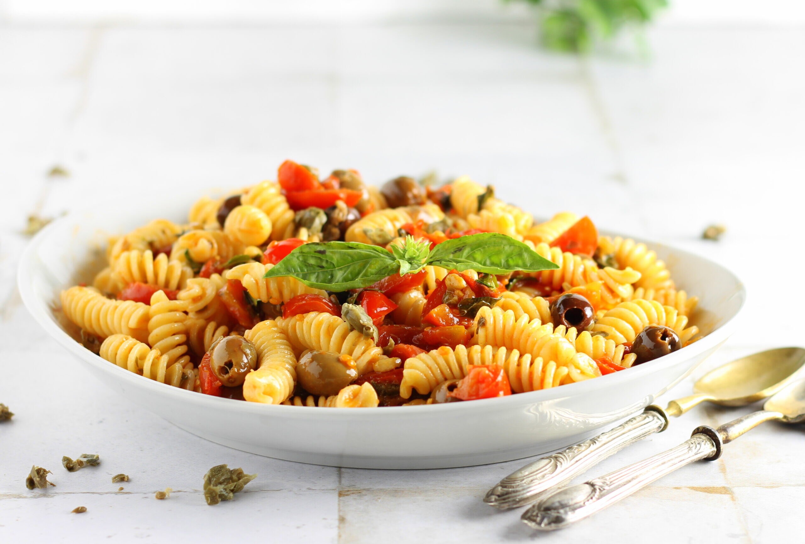 Cold pasta with cherry tomatoes, olives, and capers