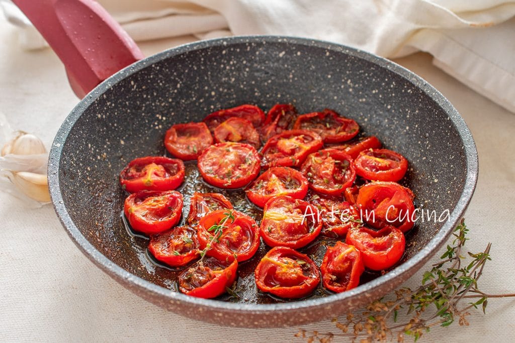 Confit cherry tomatoes in a pan