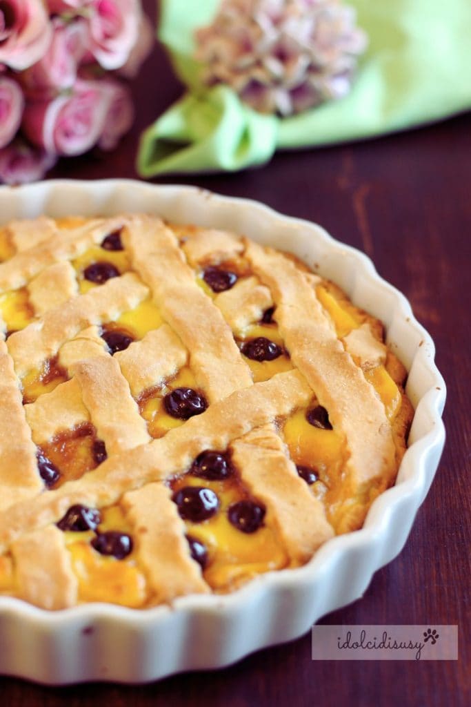 Freshly baked cream and sour cherry tart in a white mold