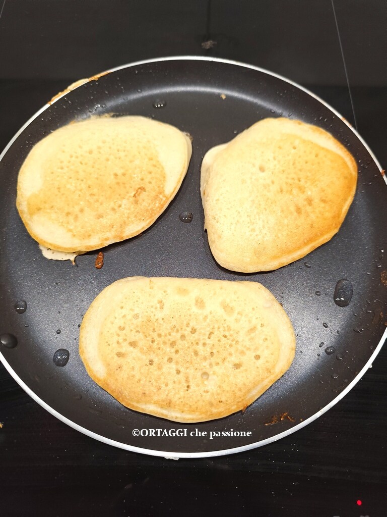 cooking second side of vegan pancakes