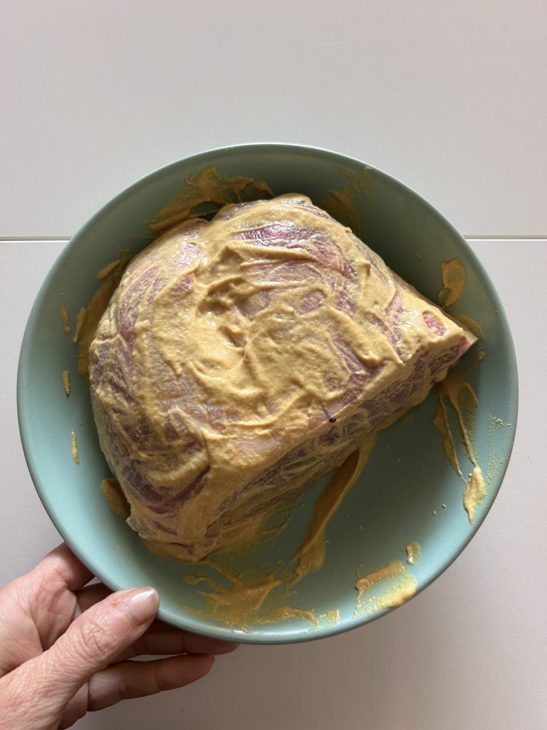pork shoulder massaged with mustard to make low-temperature pulled pork