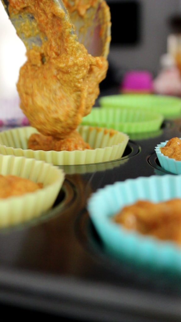 Halloween pumpkin batter distributed in spoonfuls in the molds