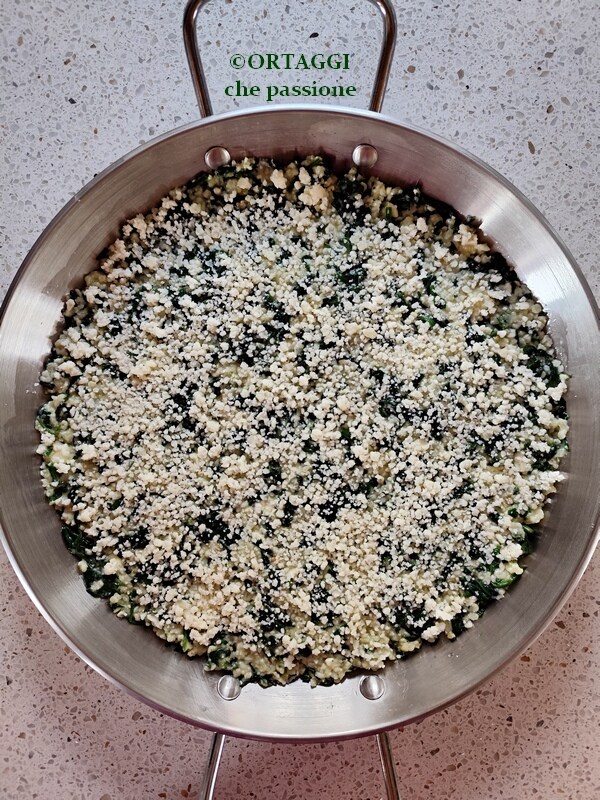 Sprinkle grated cheese on top of millet and spinach bake