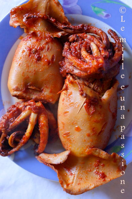 Stuffed squid with sauce on a serving plate