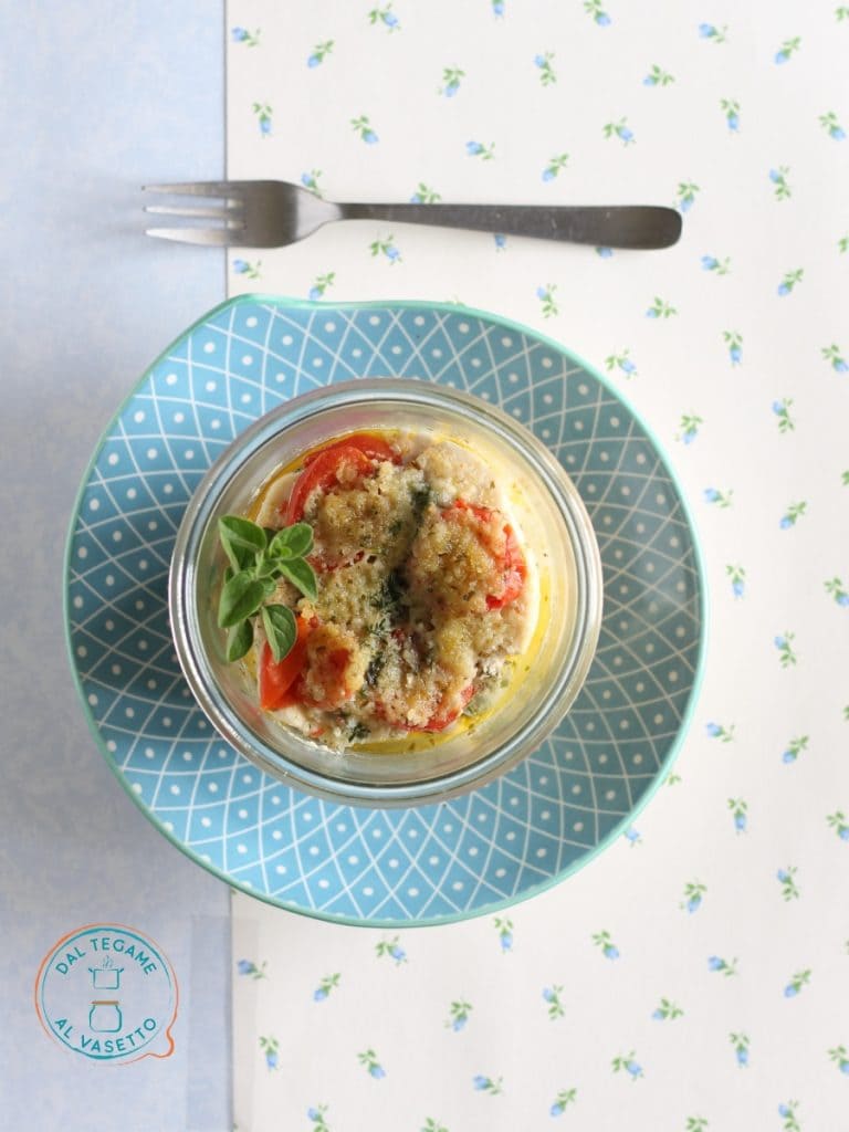 slices of swordfish cooked in a microwave jar with cherry tomatoes and herbs