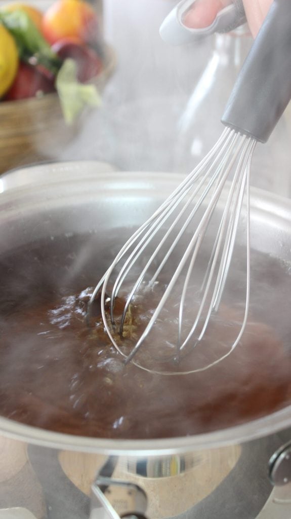 bringing the water and sugar solution to a boil as a first step in preparing the black tea
