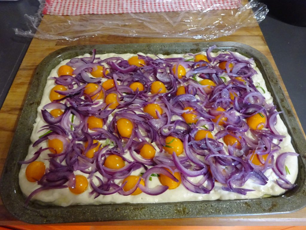 Focaccia with onions and yellow cherry tomatoes