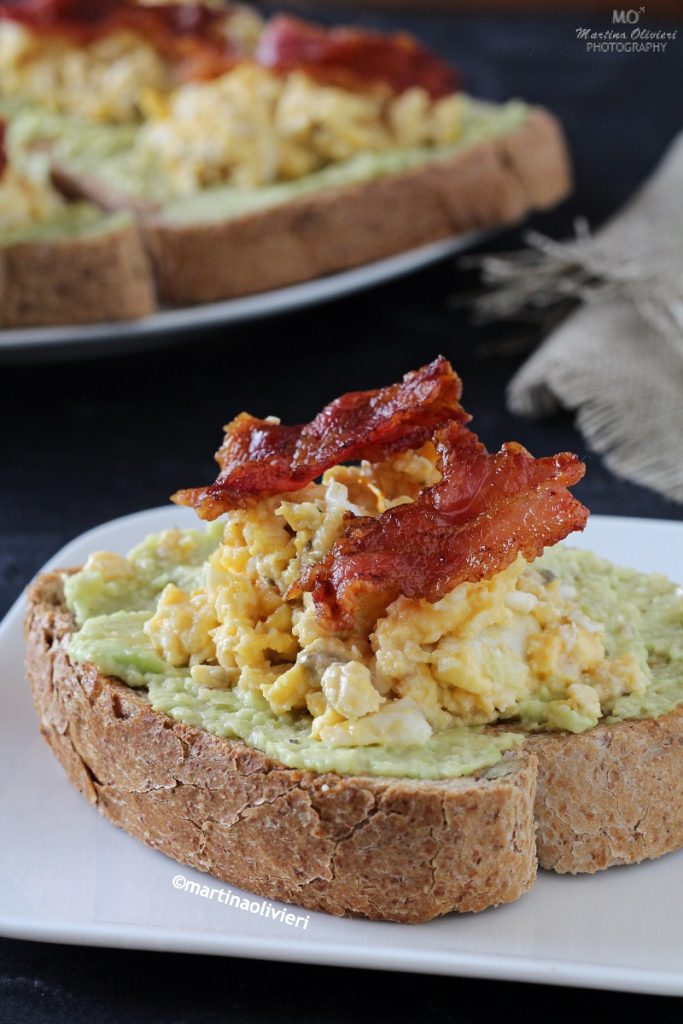 Avocado toast with scrambled eggs and bacon