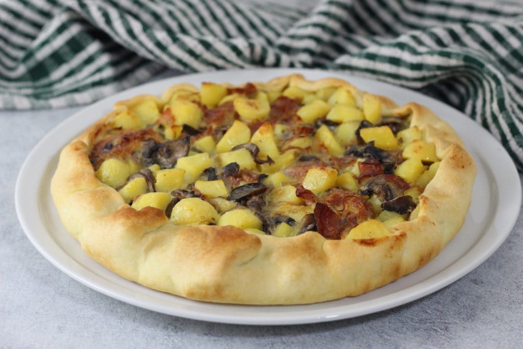 savory pie with potatoes speck and mushrooms