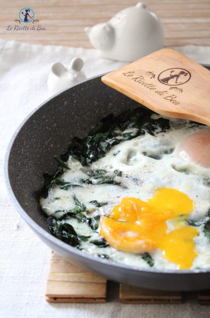 sunny side up eggs and spinach in pan