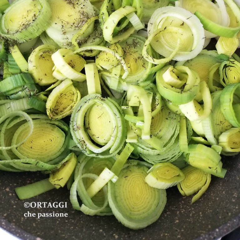 cooking sautéed leeks in a pan