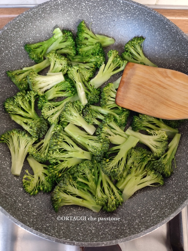 press broccoli with ladle