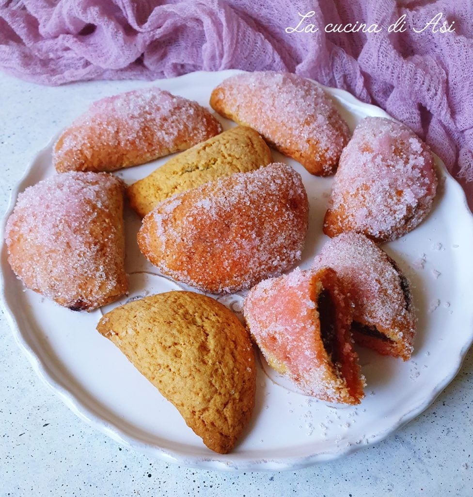 Bolognese Ravioli with Alchermes, traditional baked sweets from Emilia with soft pastry, filled with jam and coated in sugar.