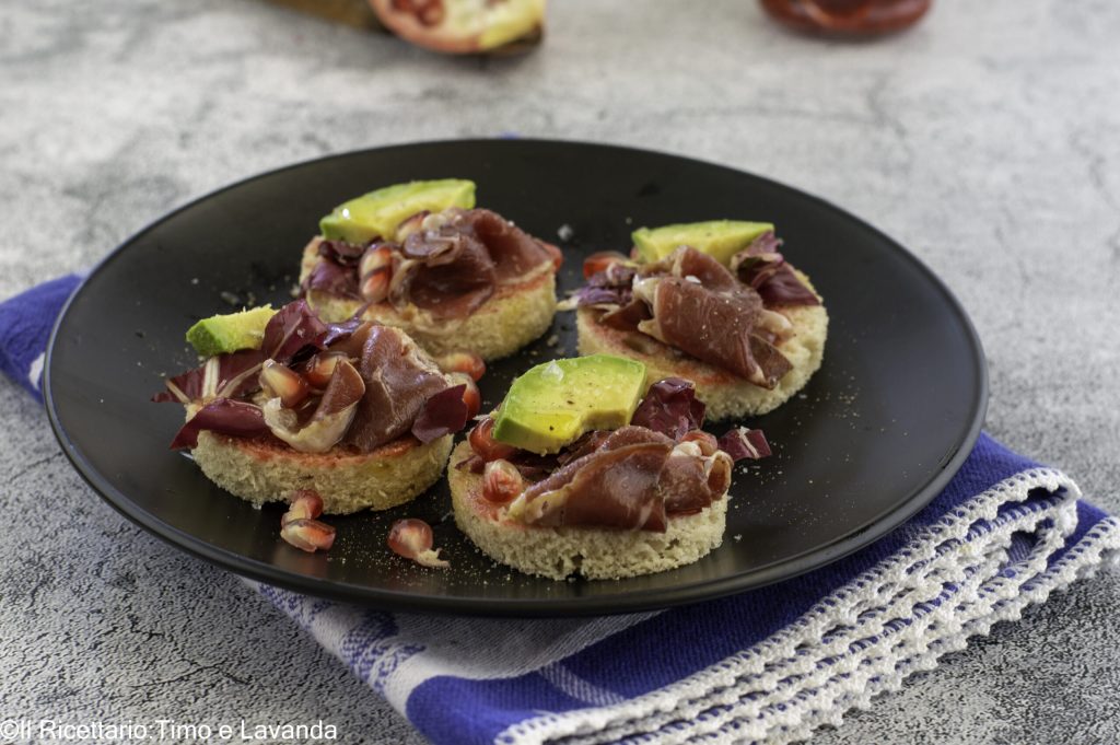 Canapés with pomegranate and duck prosciutto