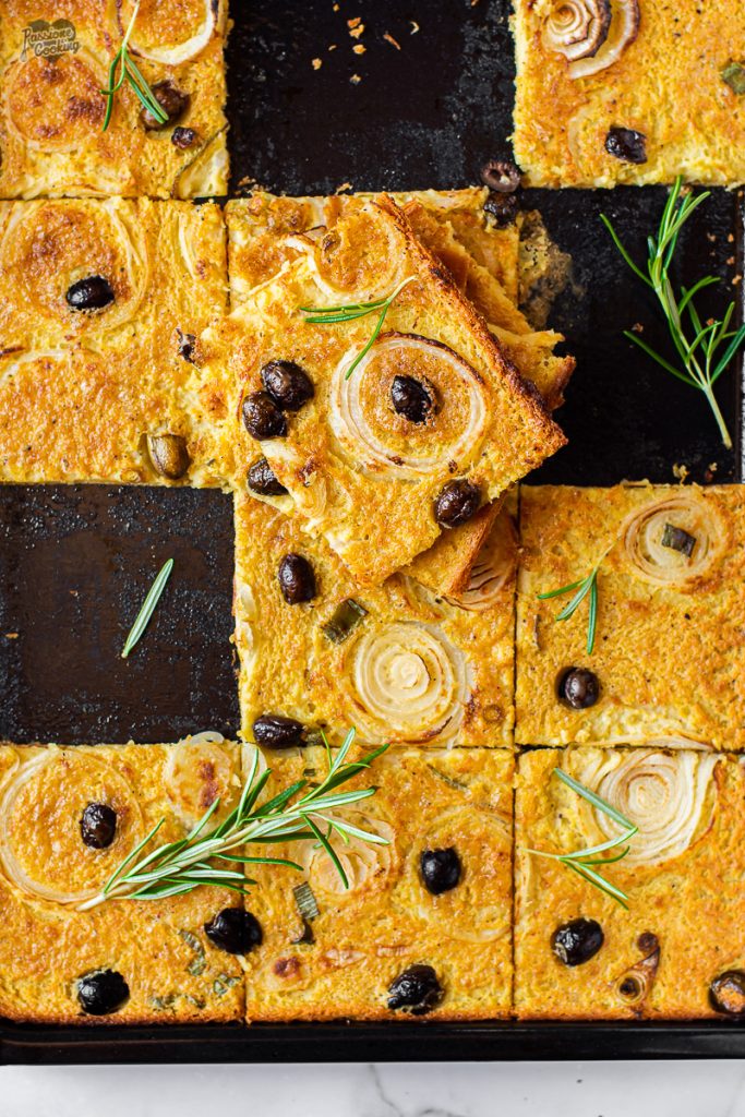 Chickpea Flatbread with Onions and Olives in a Pan