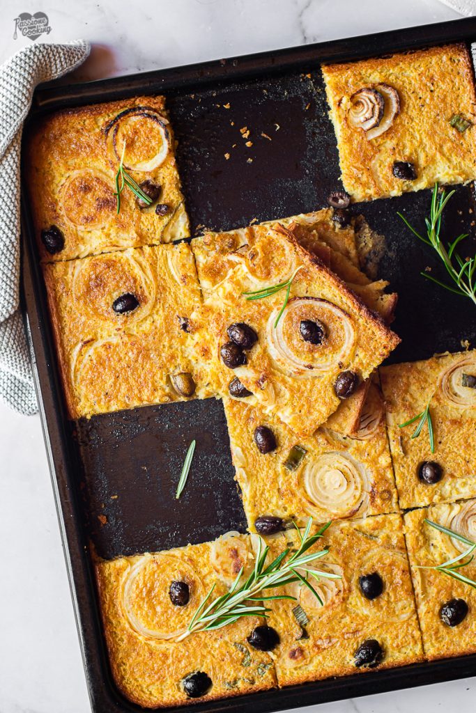 Chickpea Flatbread with Onions and Olives in a Pan