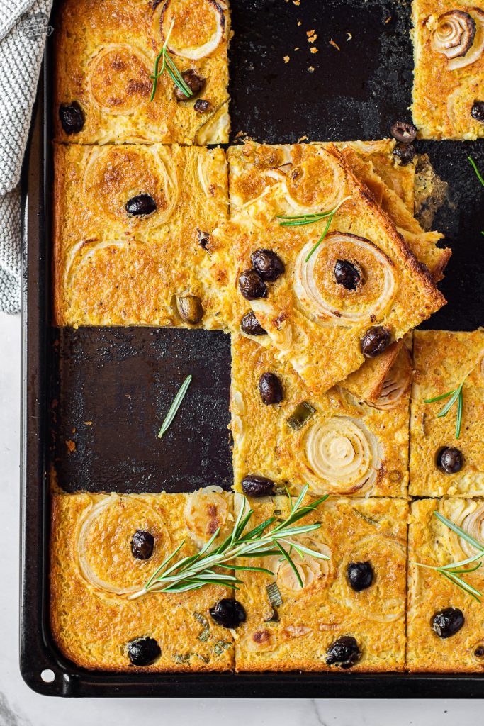 Chickpea Flatbread with Onions and Olives in a Pan