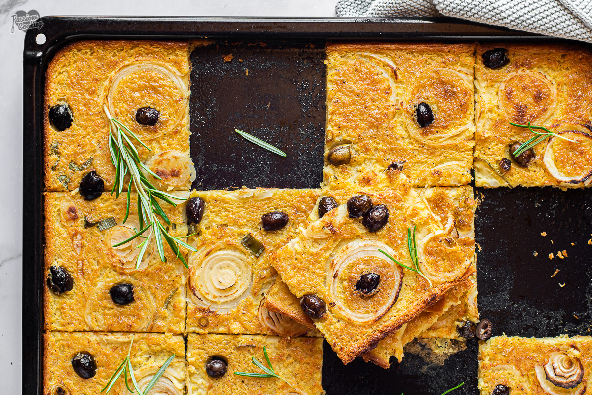 Chickpea Flatbread with Onions and Olives in a Pan