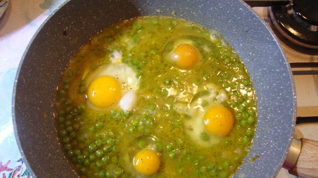 Eggs with peas in skillet stew
