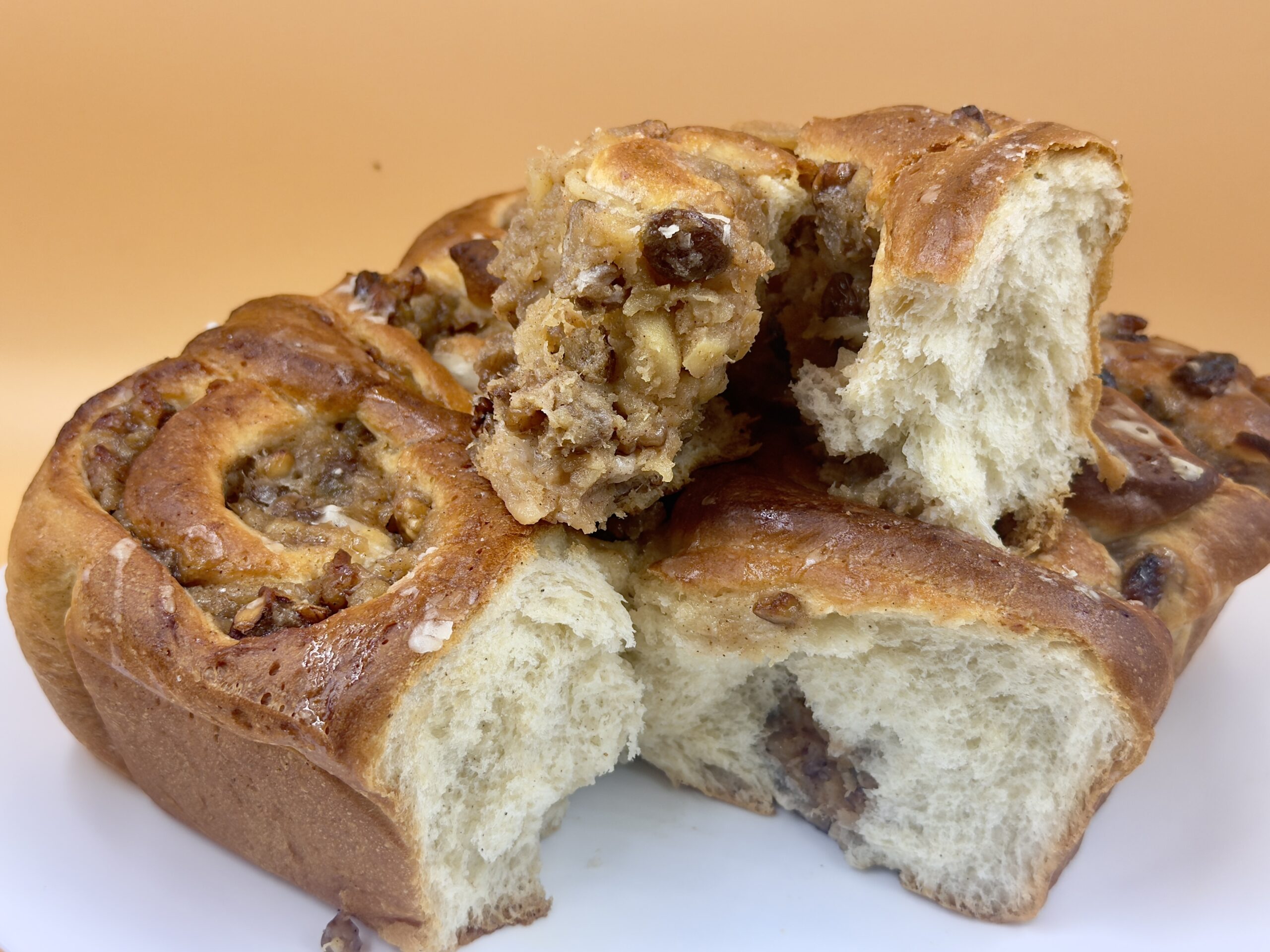 Christmas Cinnamon Rolls with Apples, Walnuts, Raisins, and Rum Glaze