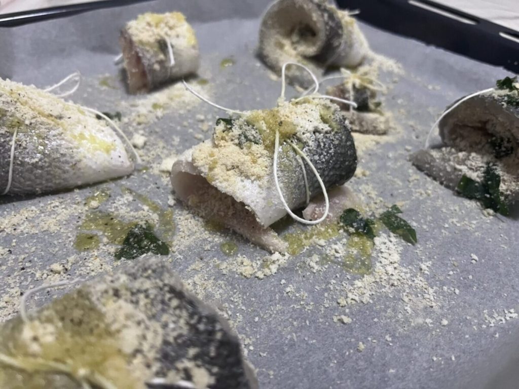 baked sea bass spirals with potatoes and cherry tomatoes