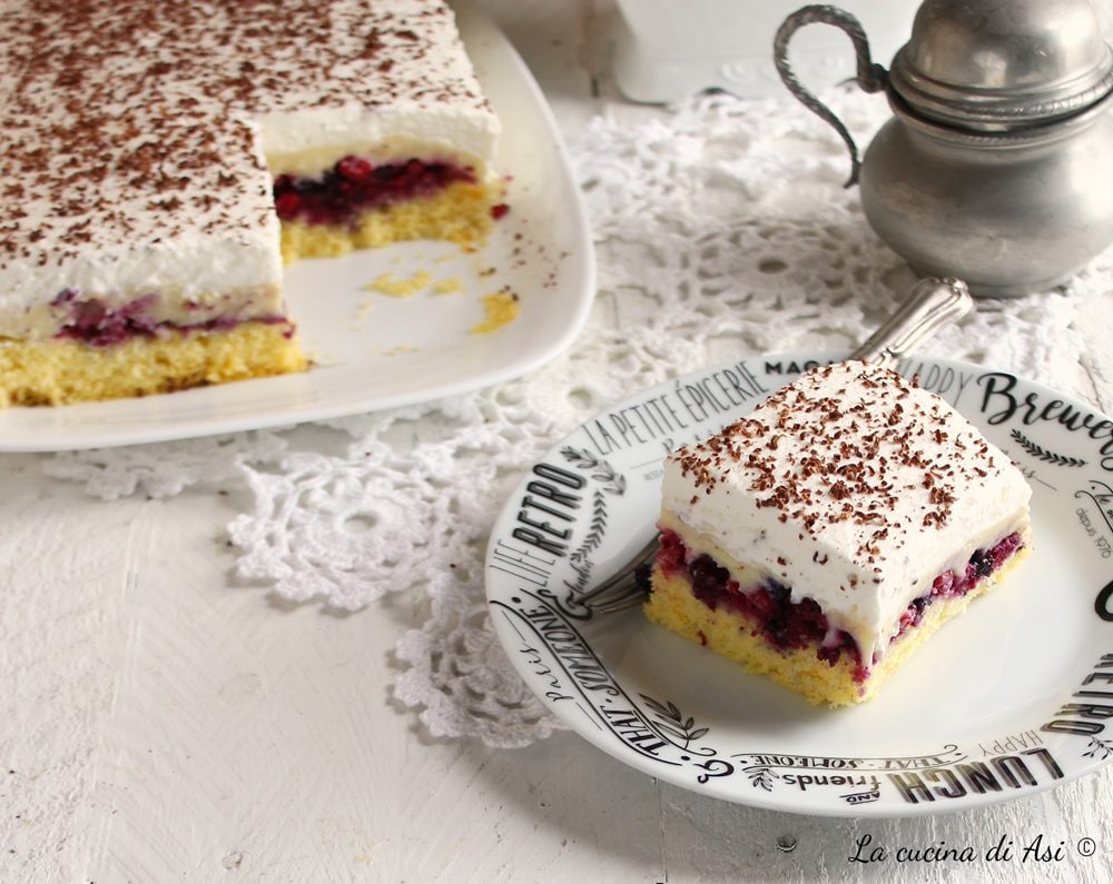 Layered dessert with cream, berries, and whipped cream