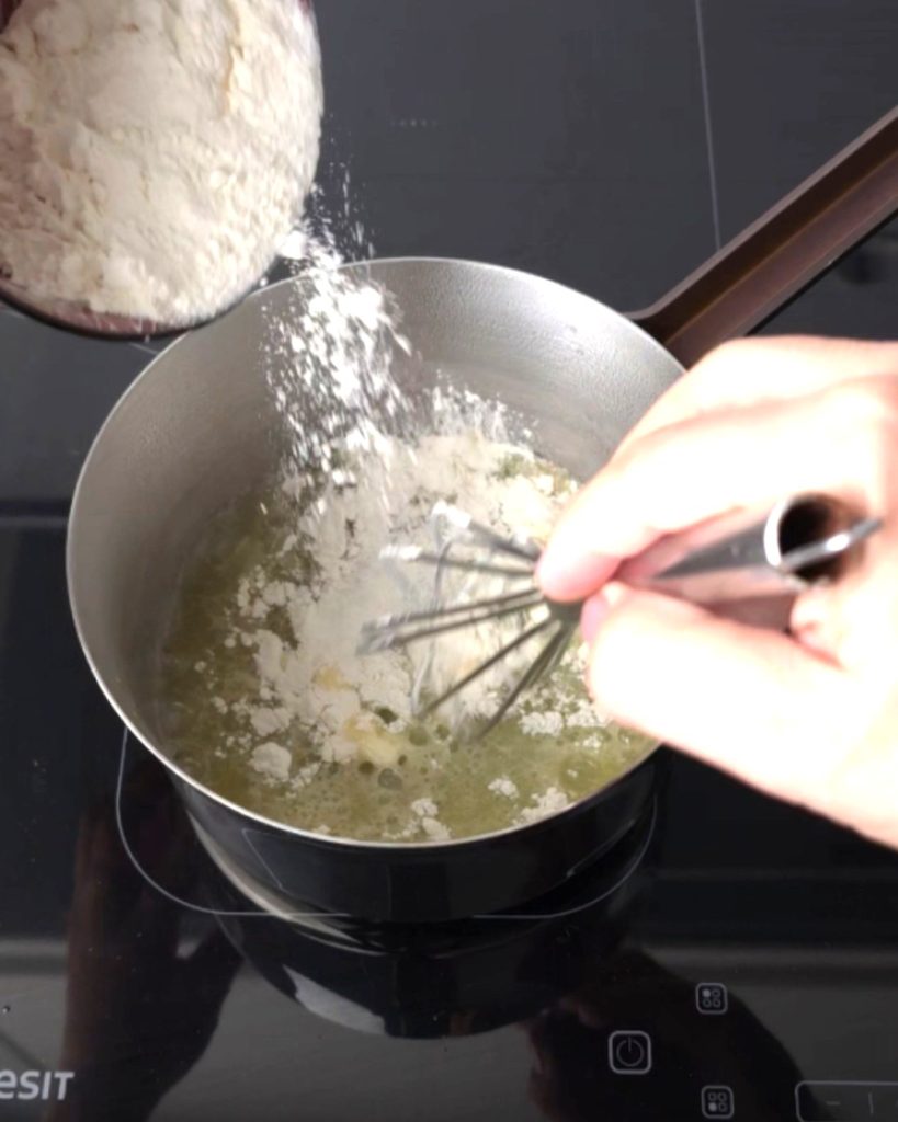 Add the flour while whisking