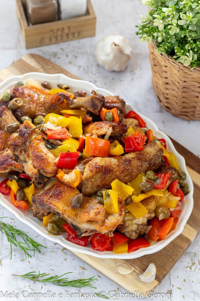 chicken with peppers, capers, and olives cooked in a pan