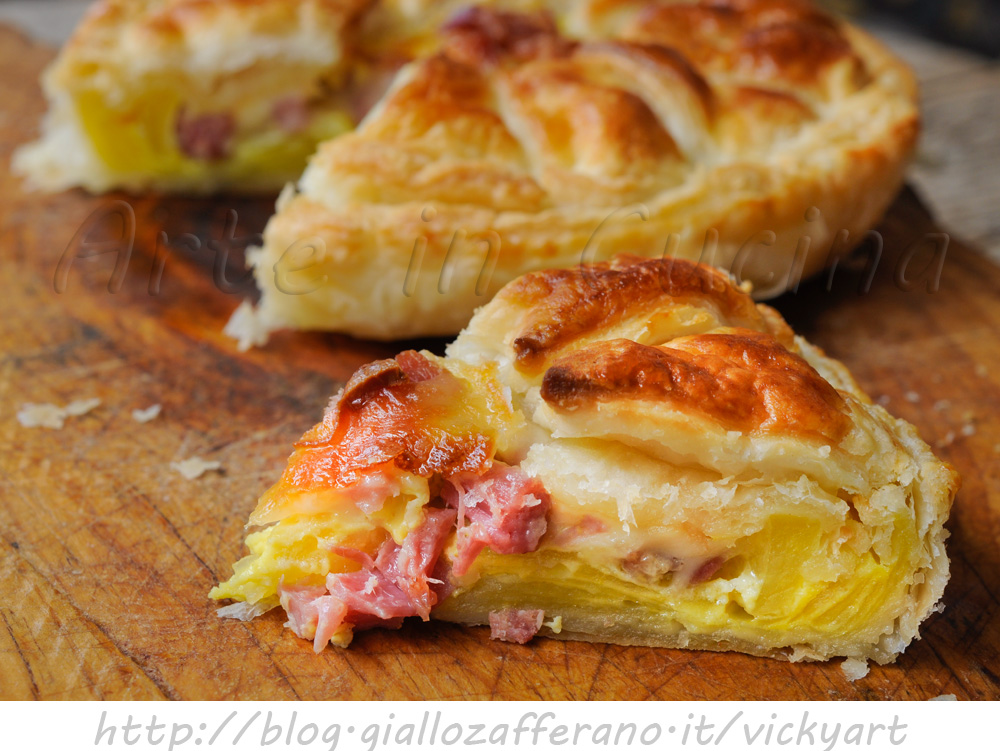 Flaky savory pie with cheeses, potatoes, and cold cuts