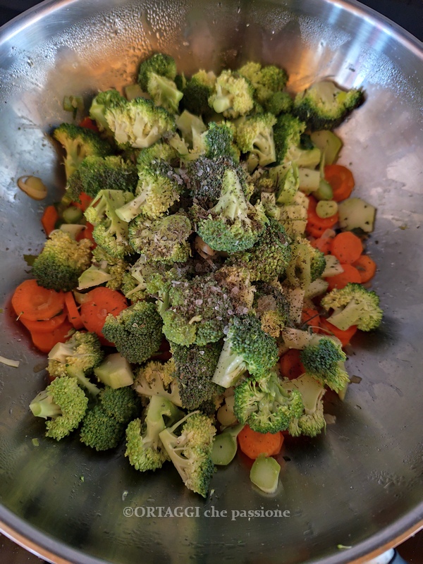 start cooking broccoli carrots and onions in the pan