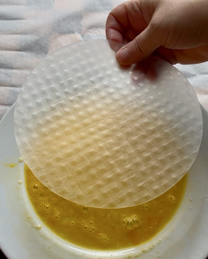 Dip the rice sheets in the beaten egg