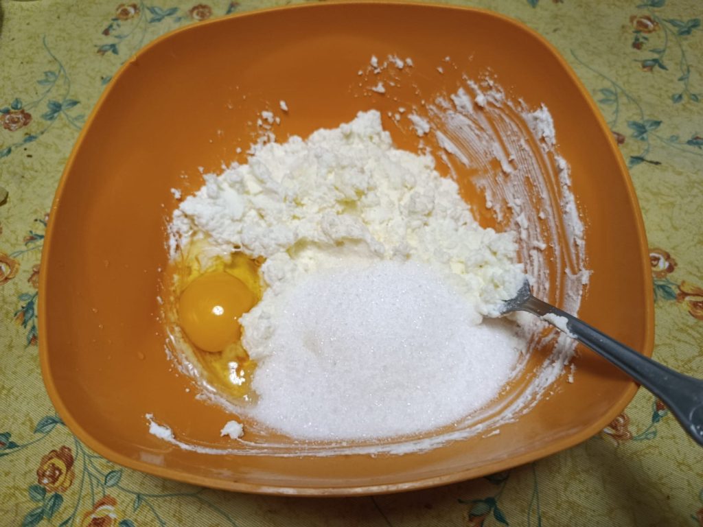 Adding egg and sugar to the ricotta mixture