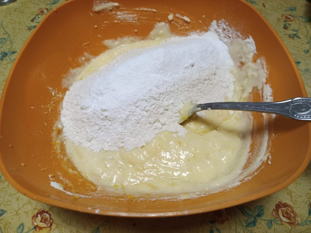 Gradually adding flour and baking powder