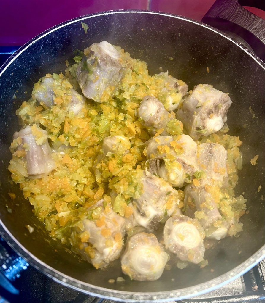 veal tail in pot with white wine during cooking