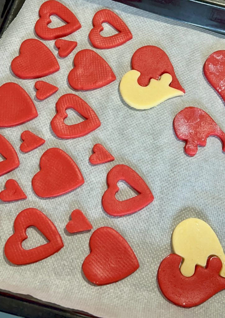 Raw two-tone shortcrust cookies on a baking sheet