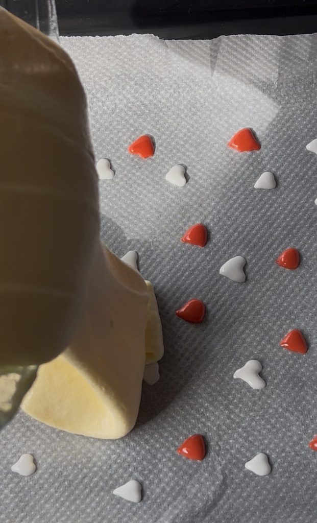 roll batter spread over heart decorations