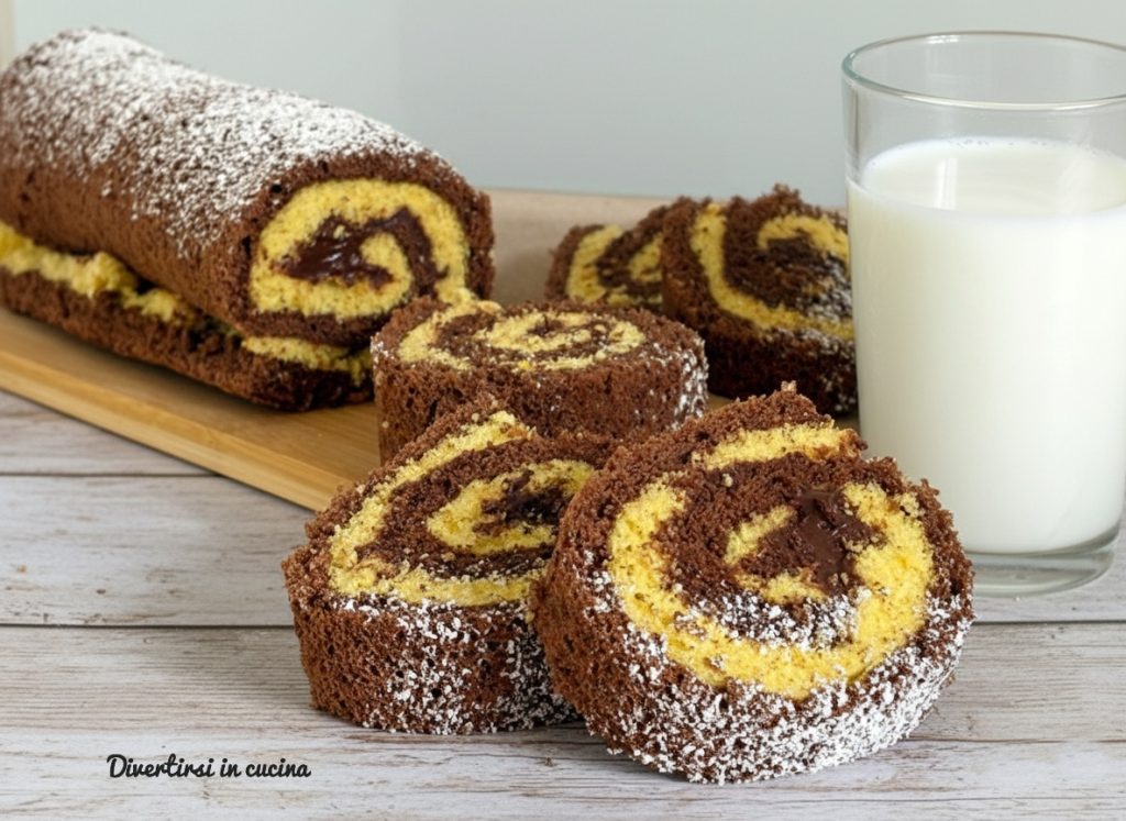 Two-tone Nutella roll cut into slices on a wooden board next to a glass of milk