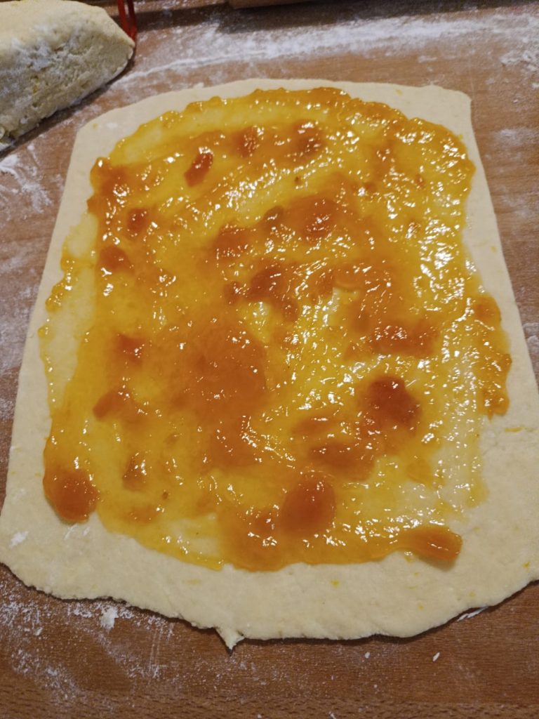 Spreading jam onto each rectangle of dough