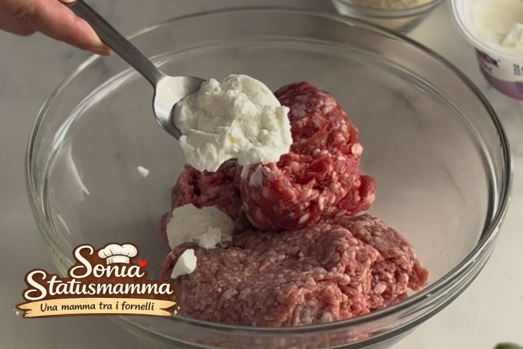 Preparing meatball mixture of sausage and ground meat with Greek yogurt in a bowl.