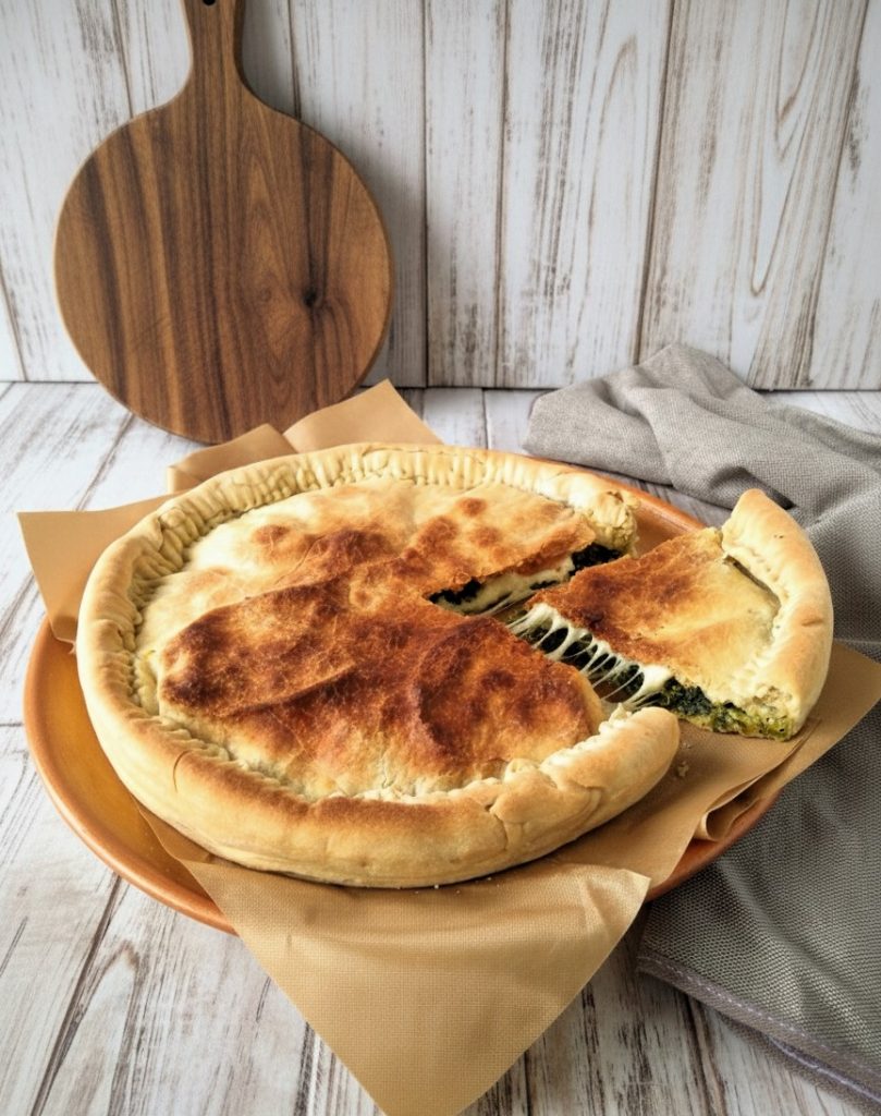 Savory pie with spinach and provola served