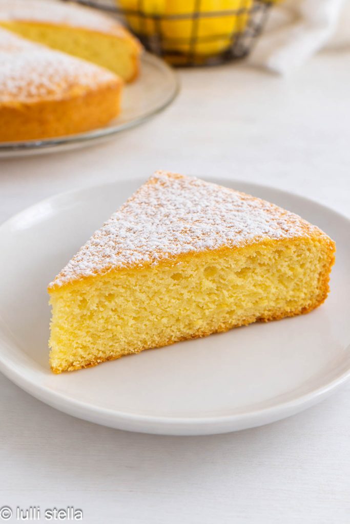 Slice of Gluten-free Lemon Margherita Cake, showing the soft, airy lemon-scented crumb