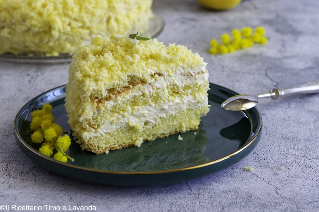 Slice of lemon mimosa cake, gluten-free, with velvety lemon cream and soft lactose-free sponge cake.