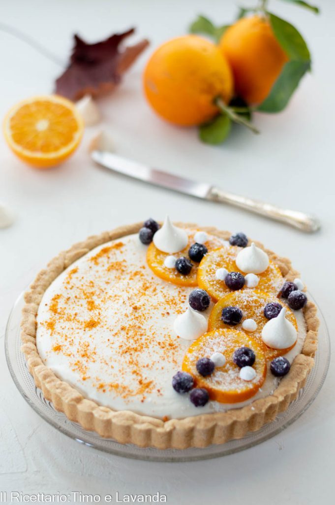 Gluten-free tart with mascarpone cream and orange marmalade, decorated with fresh orange slices