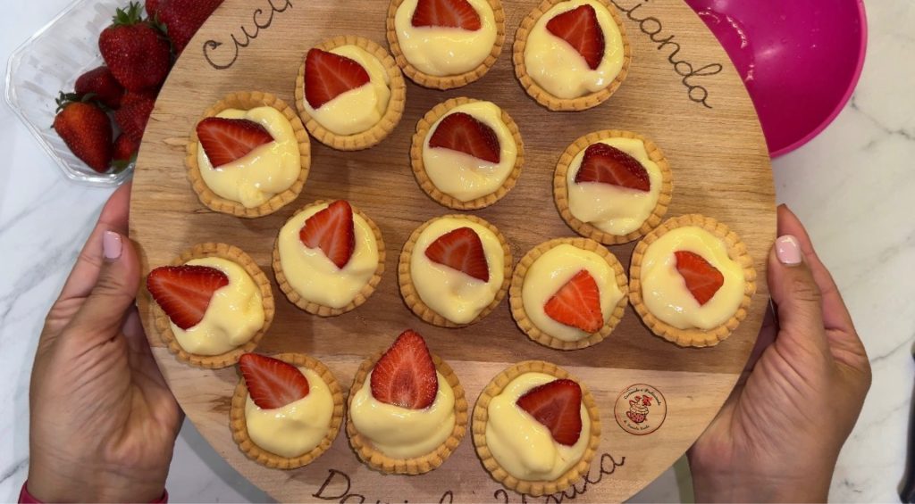 shortcrust tartlets with custard and strawberries.