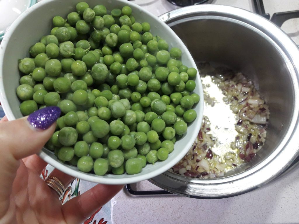 adding peas to pan