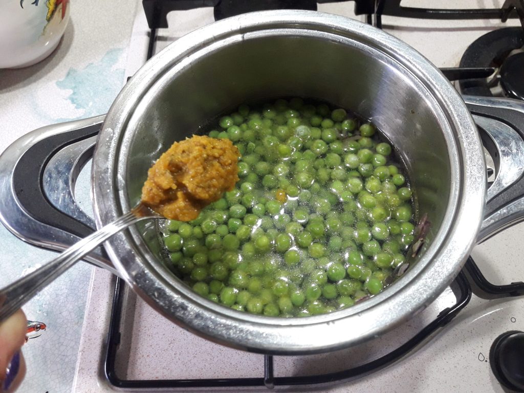 adding bouillon and cooking peas