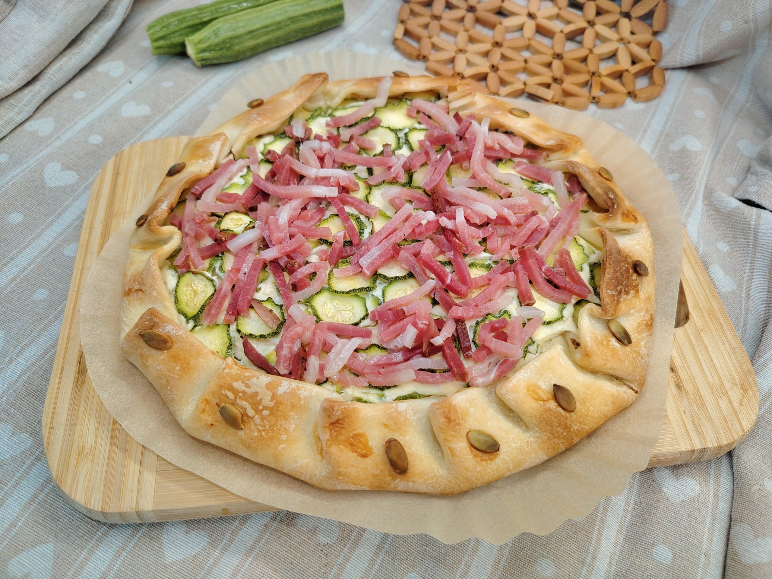Savory tart with ricotta, zucchini and speck