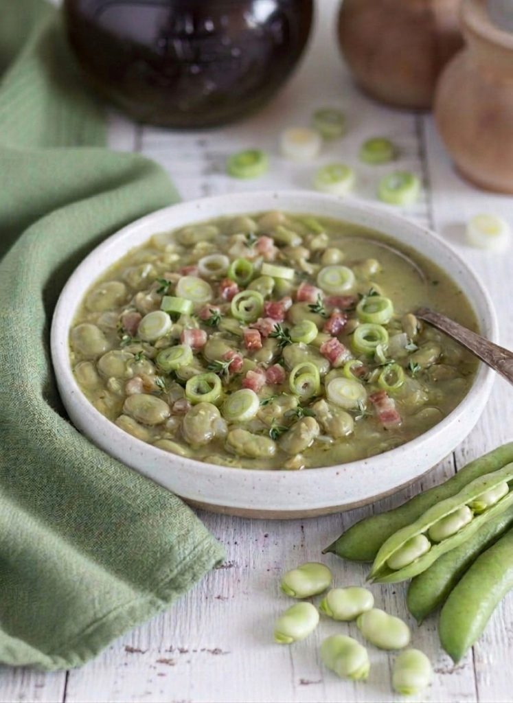 Fresh fava bean soup with pancetta and scallion